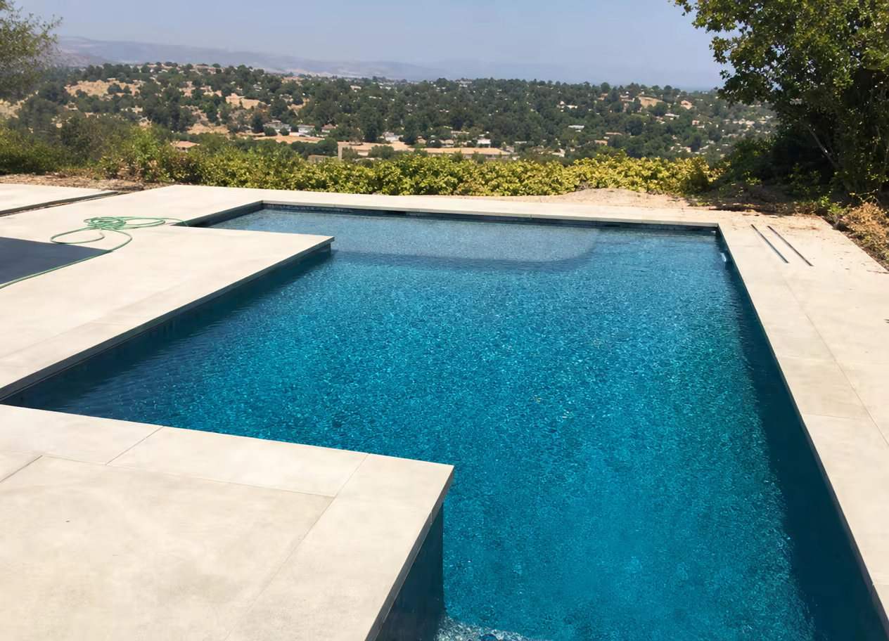 Rectangular pool on a stone terrace with valley views